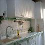 厨房的整体白色橱柜的边缘和厨房墙壁用了绿色泛白的瓷 装饰_居家装饰